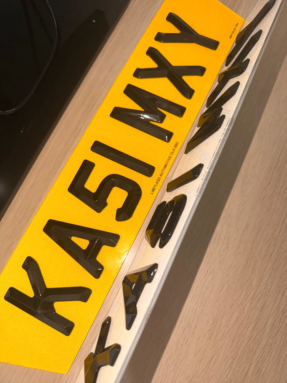 Yellow 4D bevelled number plate with raised gloss black letters